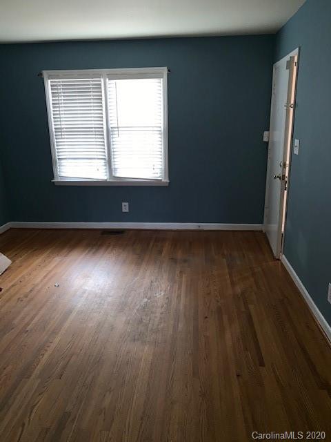 904 McAlway Road Charlotte, NC 28211 - Photo 8 of 9 an empty room with wooden floor and windows