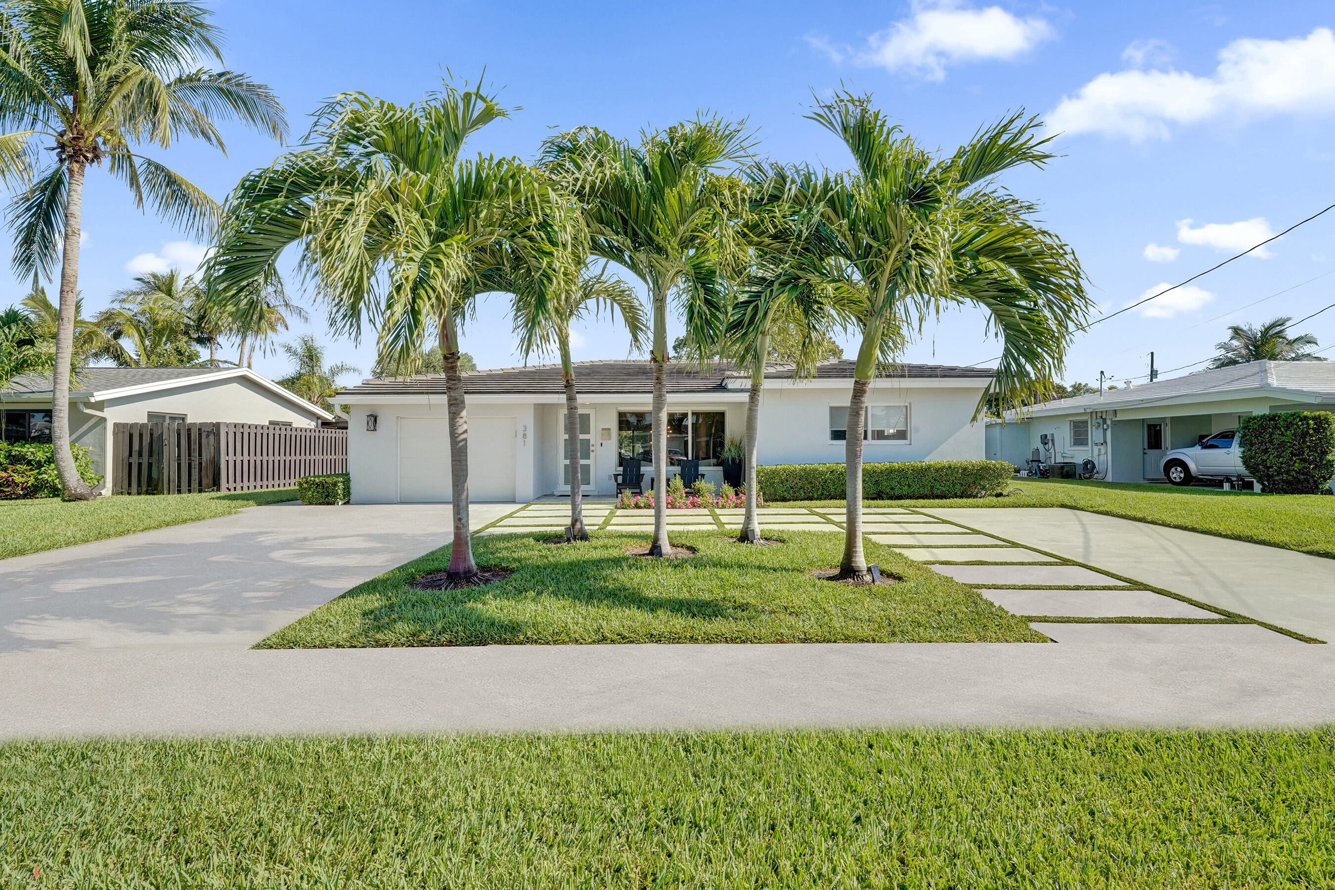 381 Southeast 3rd Street Pompano Beach, FL 33060 - Photo 2 of 41 a house with palm tree in front of it