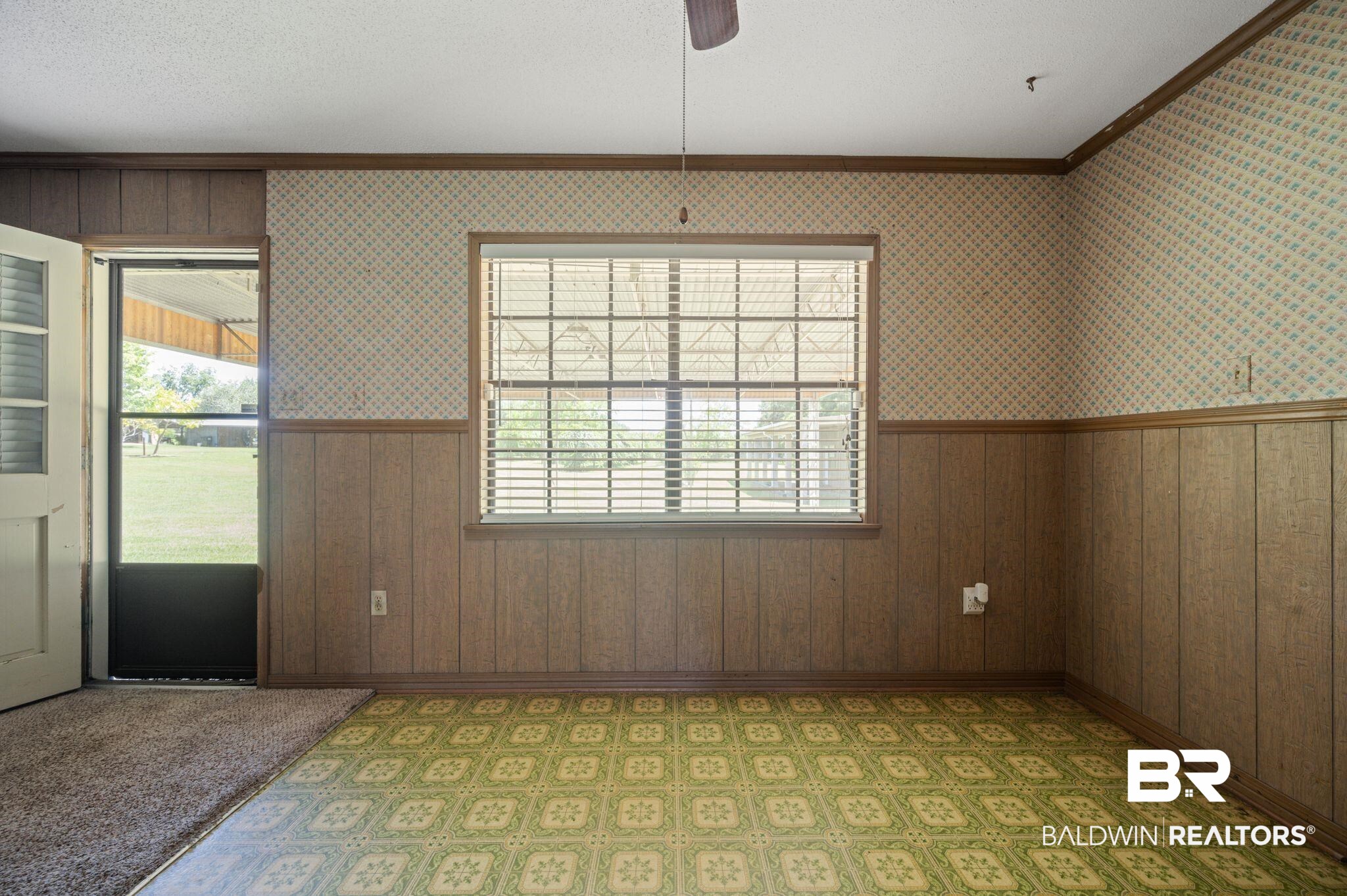 15880 Pine Grove Rd Extension West Bay Minette, AL 36507 - Photo 22 of 44 Spare room featuring carpet floors, wood walls, crown molding, and ceiling fan
