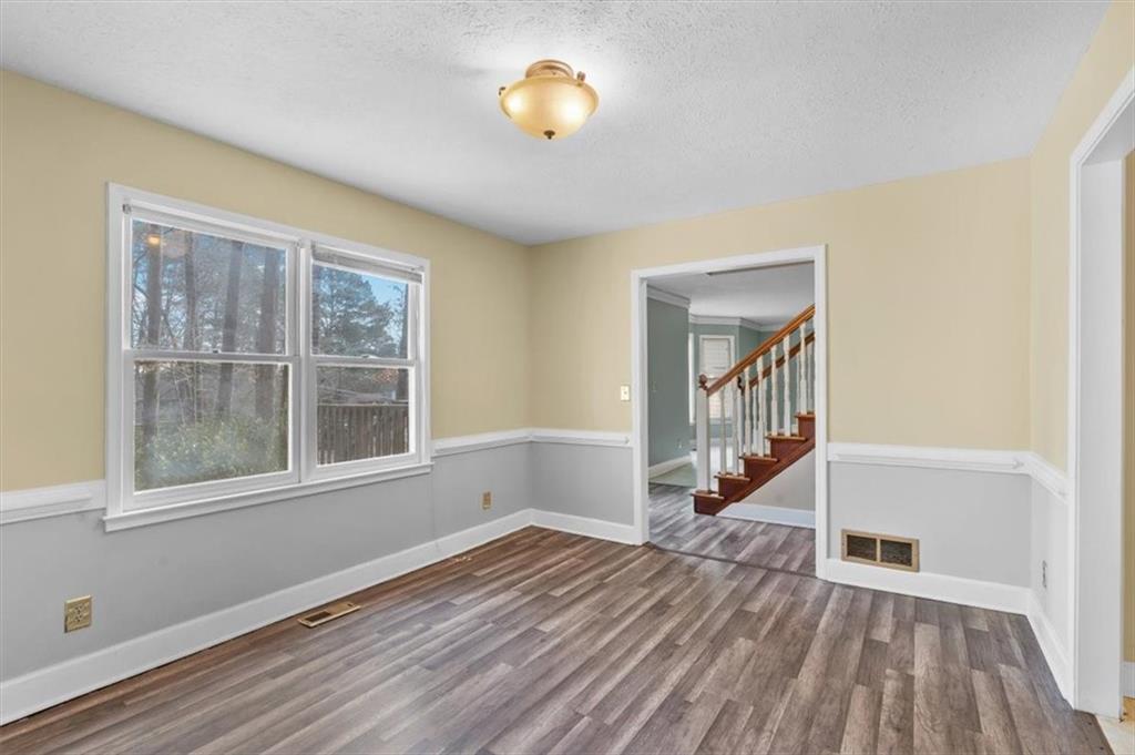 783 Pine Ridge Drive Stone Mountain, GA 30087 - Photo 11 of 32 a view of an empty room with wooden floor and a window
