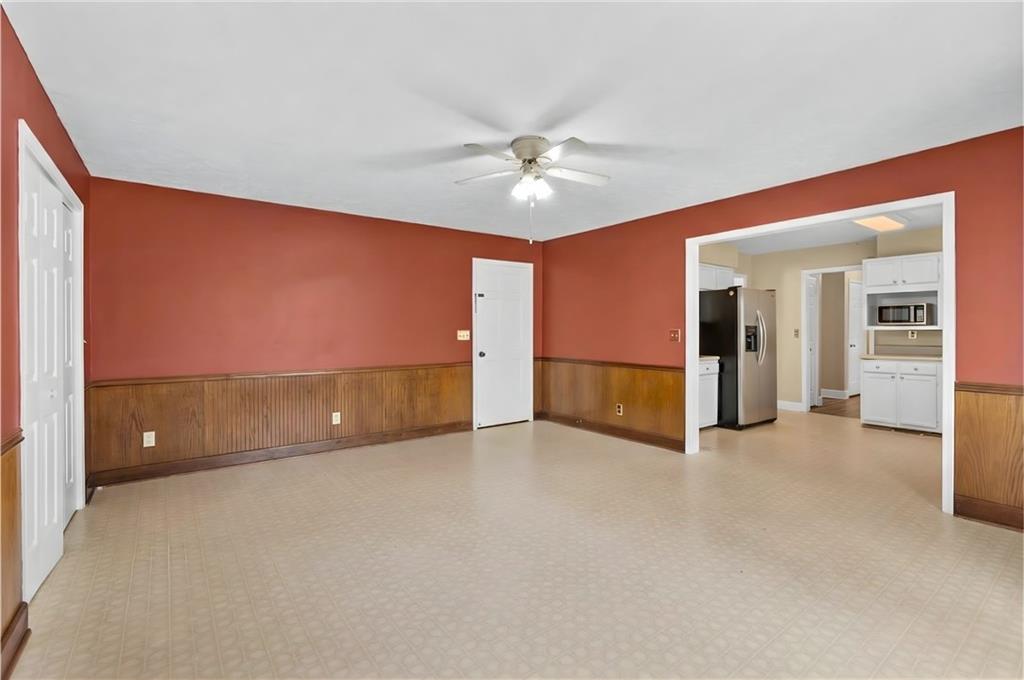 783 Pine Ridge Drive Stone Mountain, GA 30087 - Photo 13 of 32 an empty room with closet and a chandelier fan