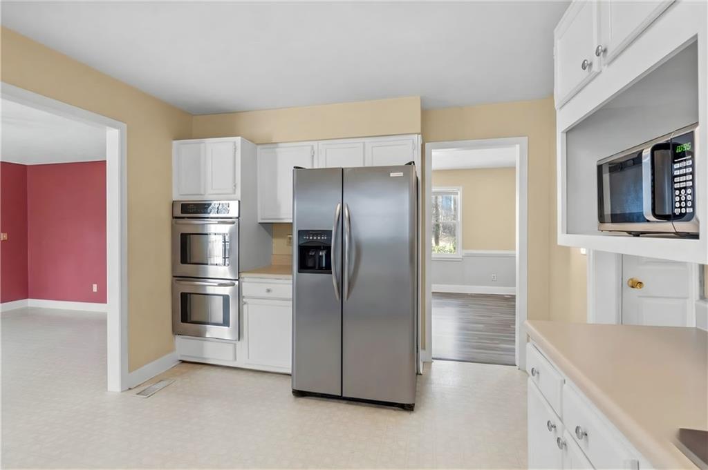 783 Pine Ridge Drive Stone Mountain, GA 30087 - Photo 15 of 32 a kitchen with stainless steel appliances a refrigerator sink and microwave