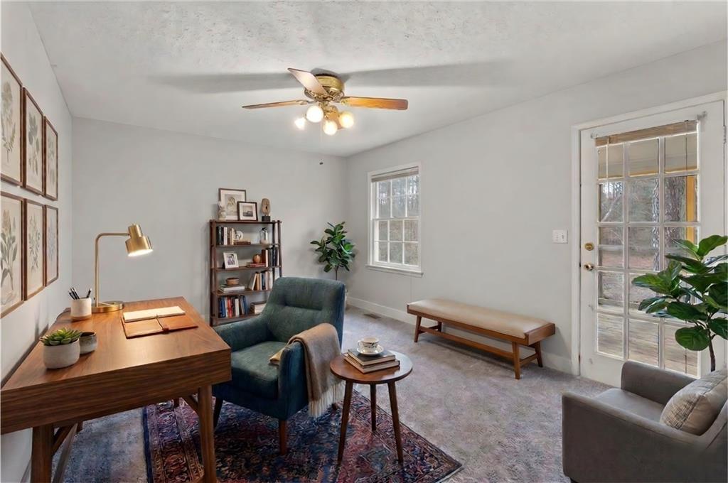 783 Pine Ridge Drive Stone Mountain, GA 30087 - Photo 23 of 32 a living room with furniture a chandelier and a window