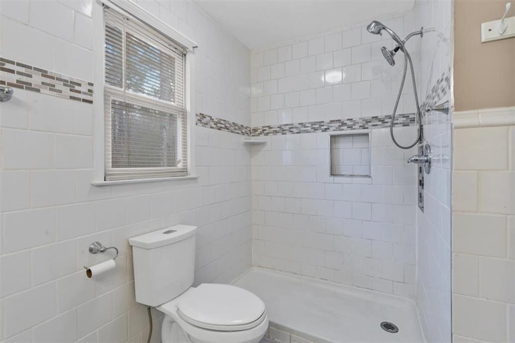 783 Pine Ridge Drive Stone Mountain, GA 30087 - Photo 24 of 32 a white toilet sitting next to a shower