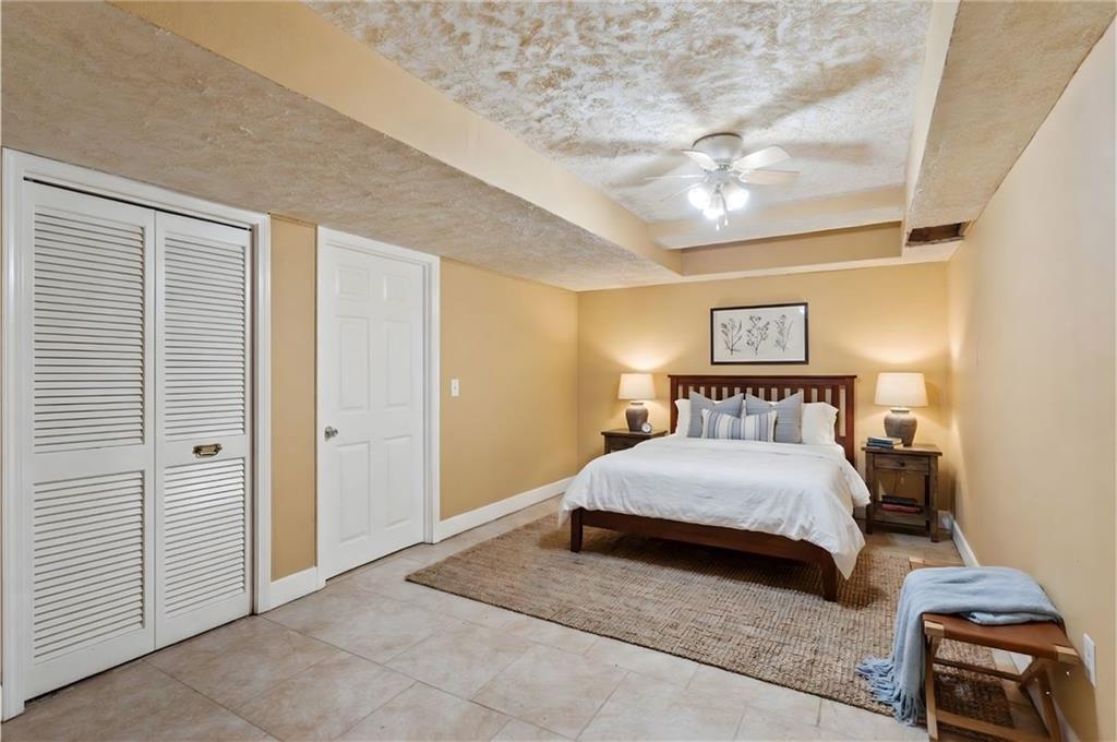 783 Pine Ridge Drive Stone Mountain, GA 30087 - Photo 25 of 32 a bedroom with a bed and a night stand