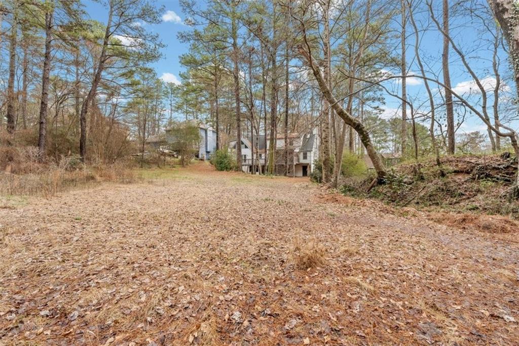 783 Pine Ridge Drive Stone Mountain, GA 30087 - Photo 28 of 32 a backyard of a house with lots of green space