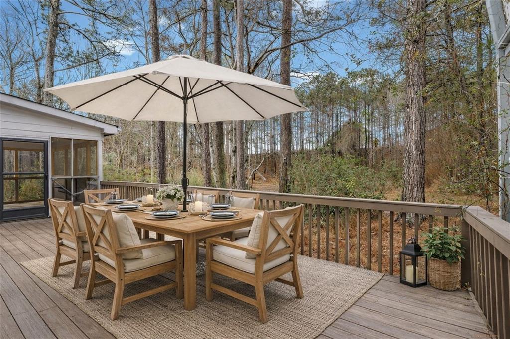 783 Pine Ridge Drive Stone Mountain, GA 30087 - Photo 6 of 32 a view of a patio with a table and chairs under an umbrella
