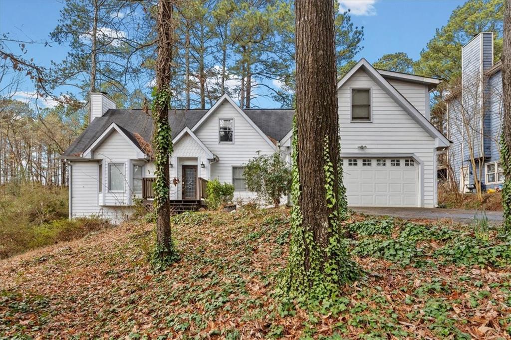 783 Pine Ridge Drive Stone Mountain, GA 30087 - Photo 7 of 32 a front view of a house with a yard and garage