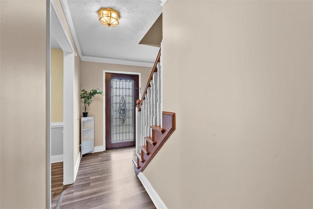 783 Pine Ridge Drive Stone Mountain, GA 30087 - Photo 10 of 32 a view of a hallway with wooden floor and stairs