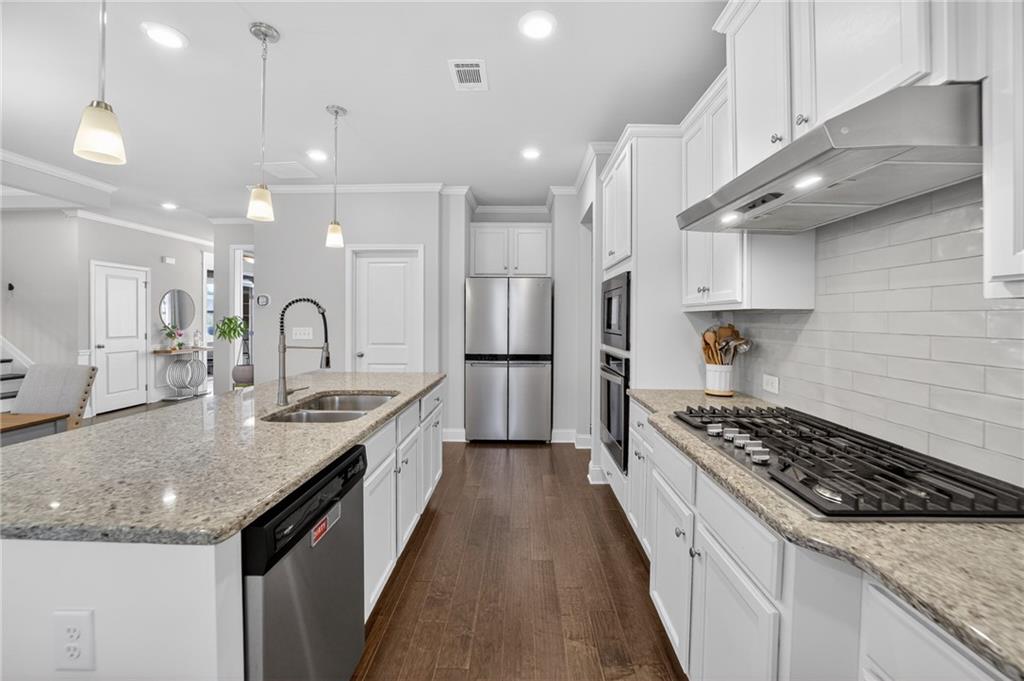 3586 Andover Way Buford, GA 30519 - Photo 15 of 63 a kitchen with stainless steel appliances granite countertop a sink stove and refrigerator