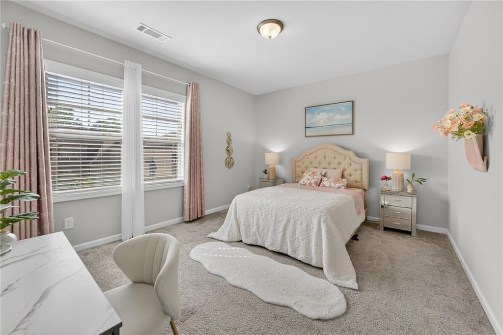 3586 Andover Way Buford, GA 30519 - Photo 32 of 63 a bedroom with a large bed and a window