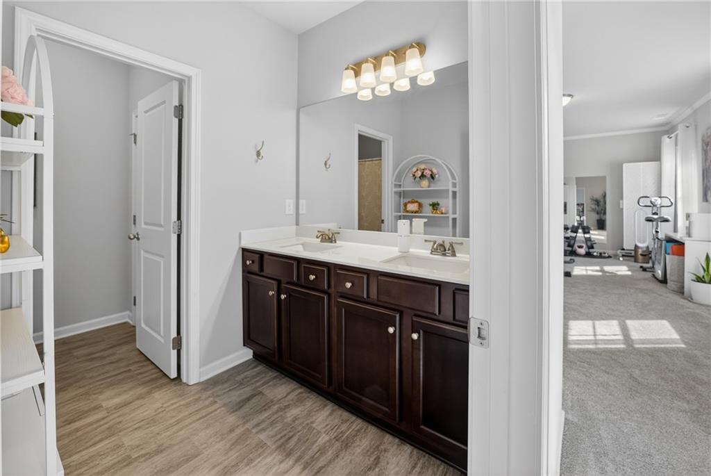 3586 Andover Way Buford, GA 30519 - Photo 33 of 63 a spacious bathroom with a double vanity sink and a mirror