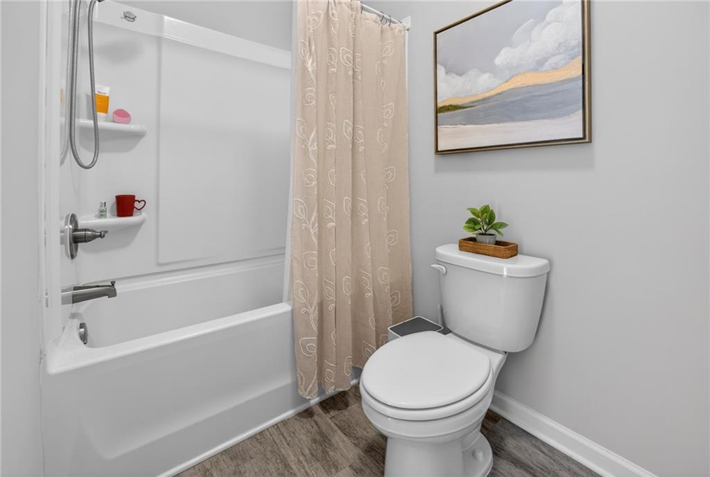 3586 Andover Way Buford, GA 30519 - Photo 34 of 63 a bathroom with a toilet and a shower
