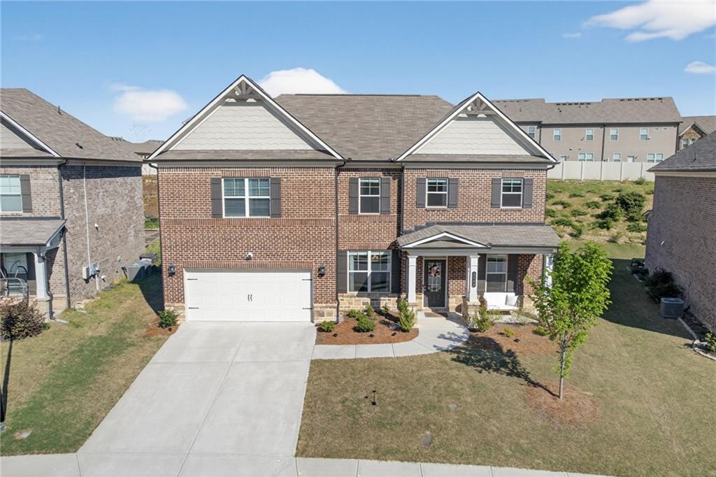 3586 Andover Way Buford, GA 30519 - Photo 47 of 63 a view of a white house with large windows next to a yard
