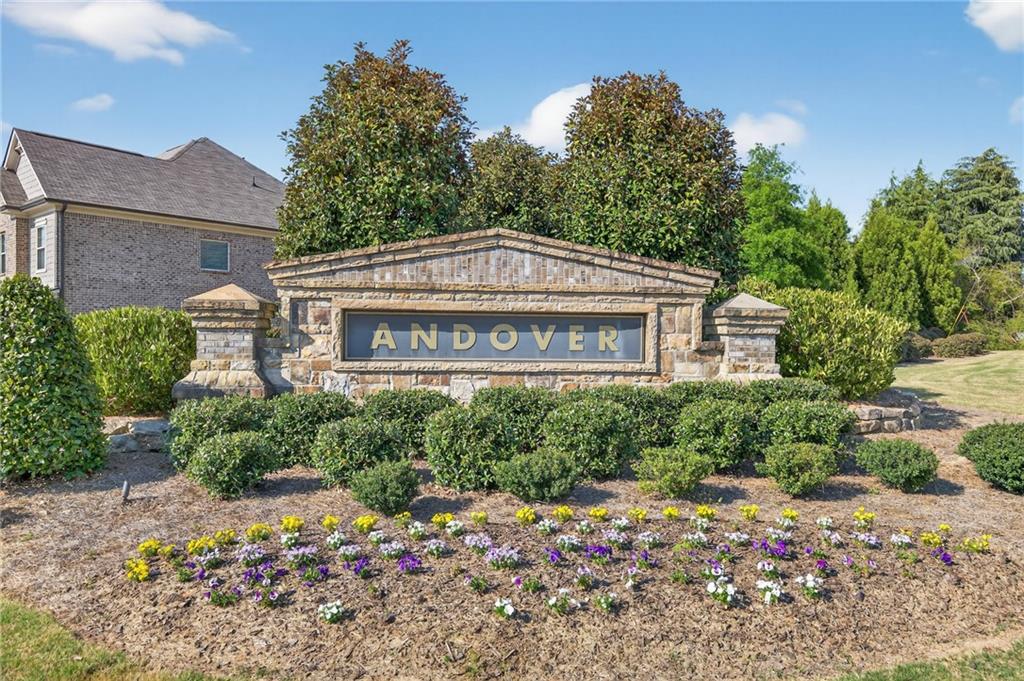 3586 Andover Way Buford, GA 30519 - Photo 60 of 63 a front view of a house with a yard and a lot of flower plants
