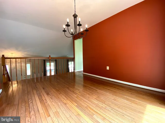 a porch with a bench next to a yard