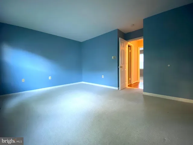 an empty room with a window and wooden floor