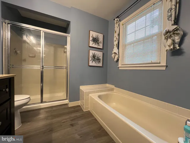 a bathroom with a bathtub and a shower