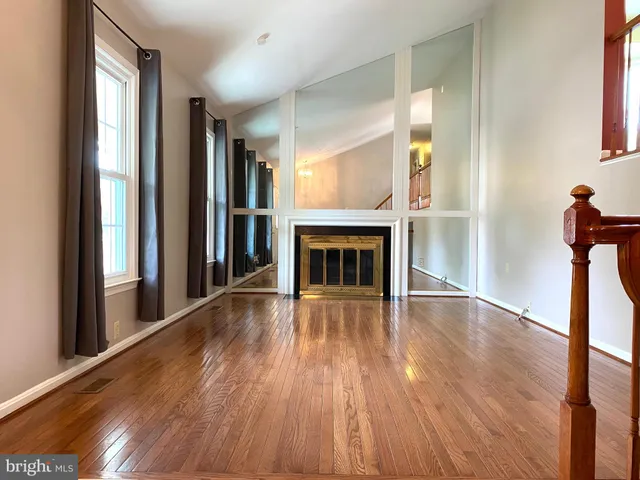 a view of a workspace with furniture and wooden floor