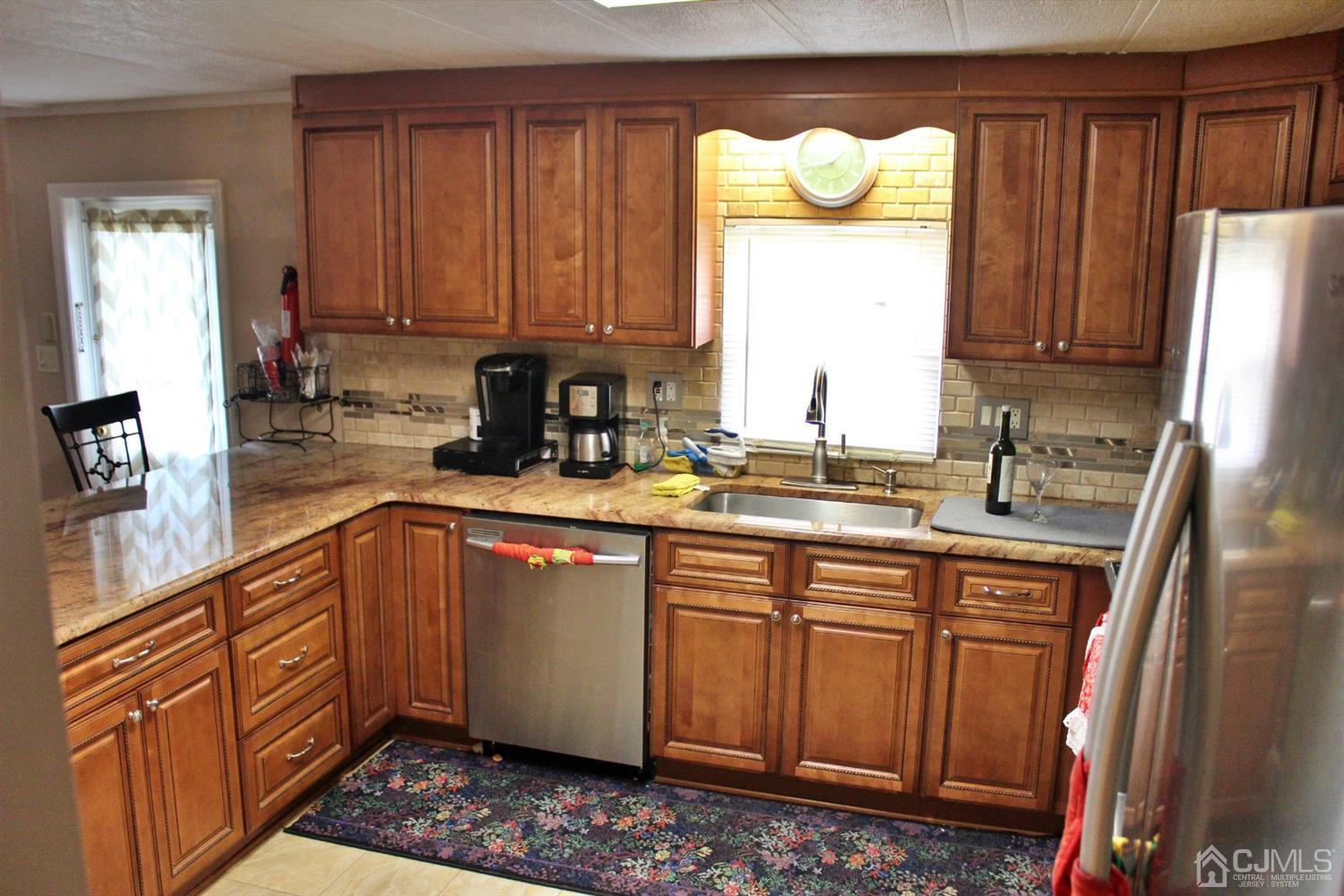 4 Longfellow Road North Brunswick, NJ 08902 - Photo 3 of 10 a kitchen with stainless steel appliances granite countertop a sink refrigerator and cabinets