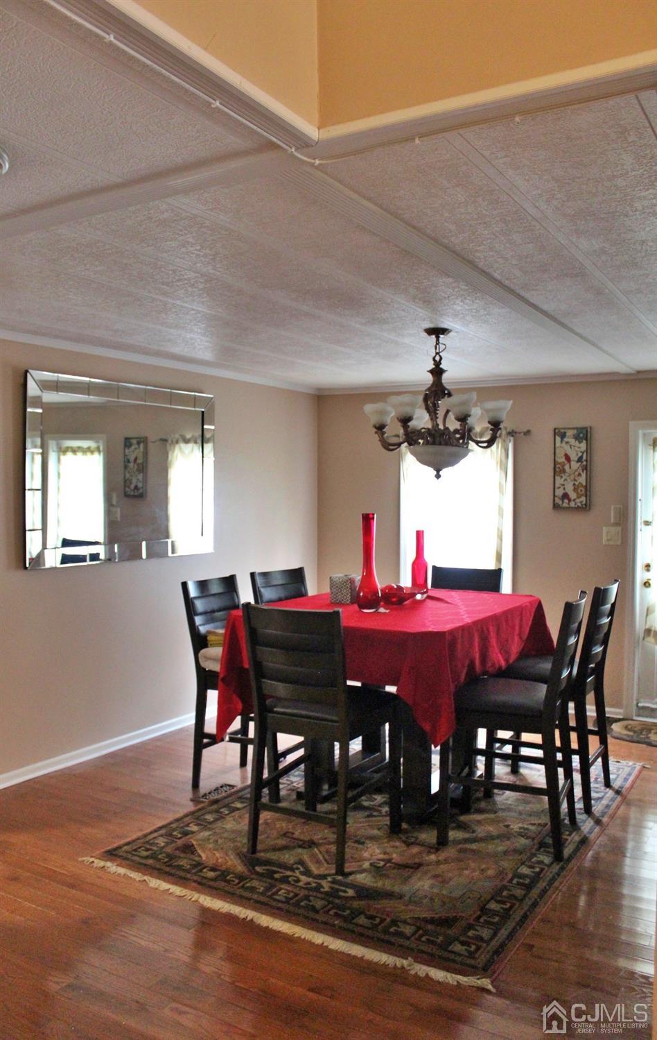 4 Longfellow Road North Brunswick, NJ 08902 - Photo 5 of 10 a dining room with furniture wooden floor and chandelier