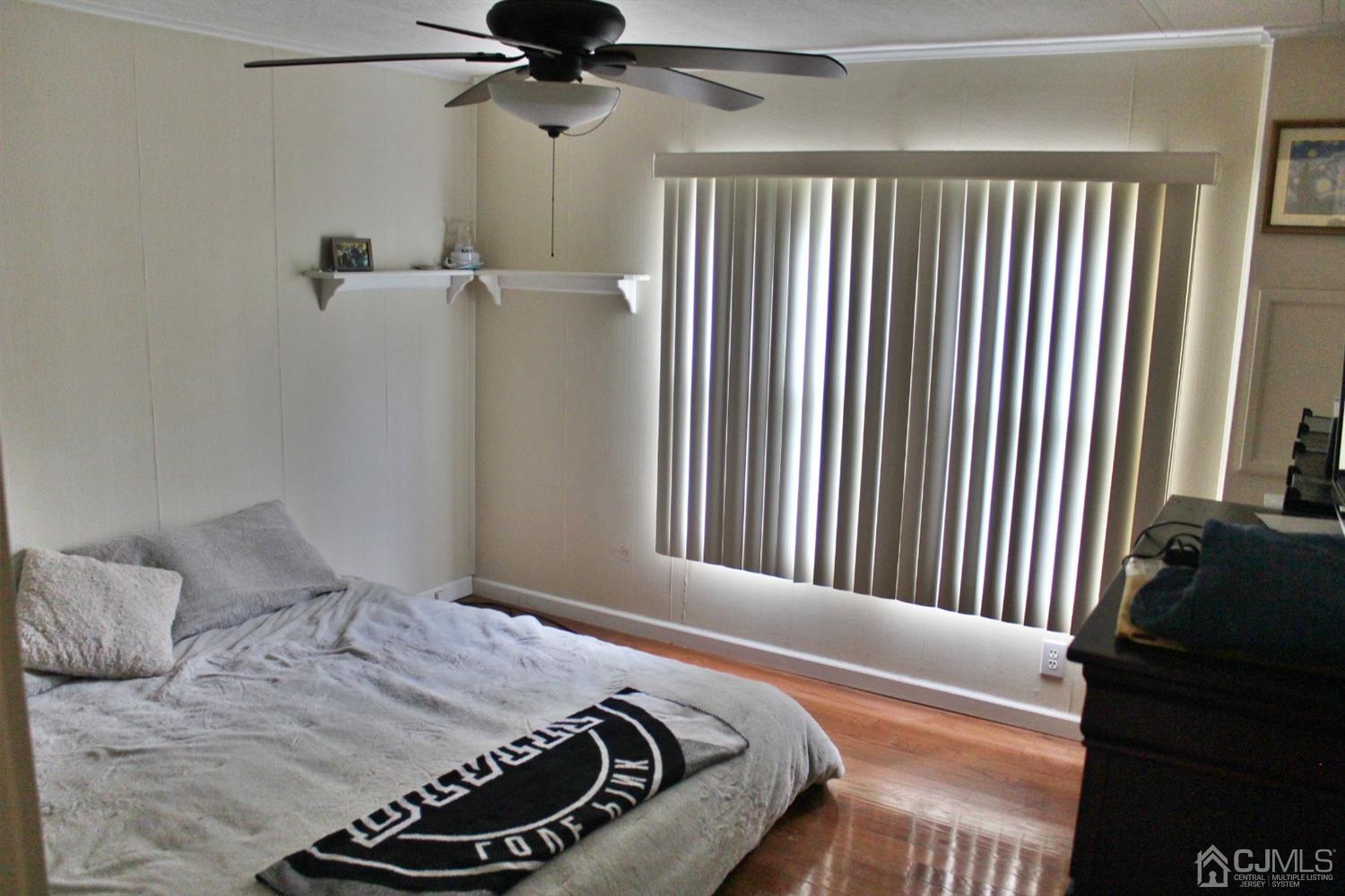 4 Longfellow Road North Brunswick, NJ 08902 - Photo 6 of 10 a bedroom with a bed and a chandelier