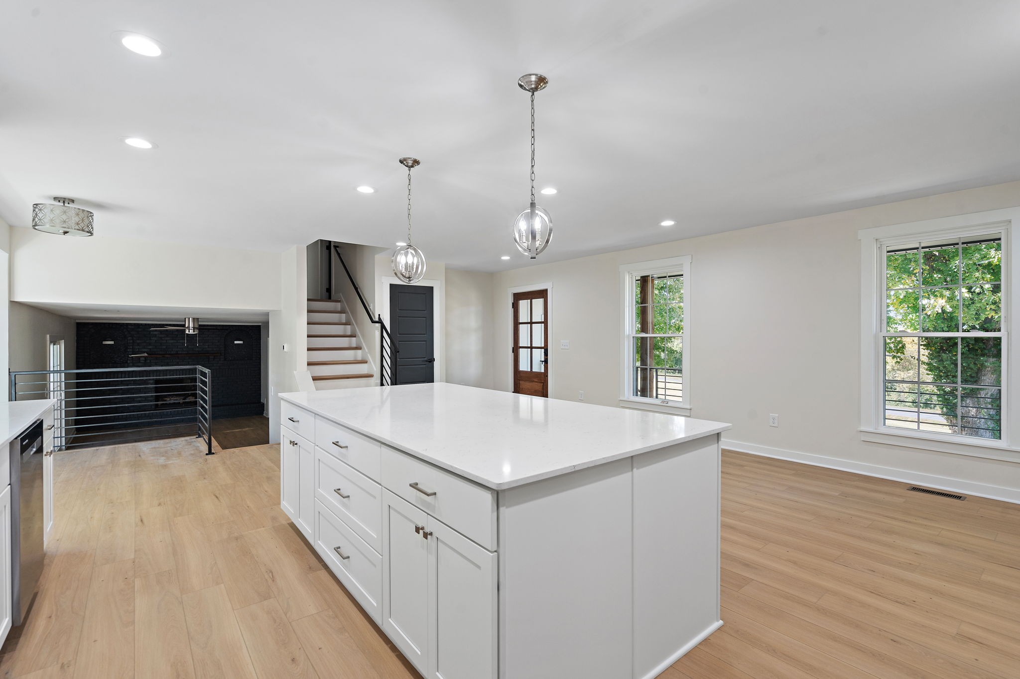 1015 Lock 4 Road Gallatin, TN 37066 - Photo 11 of 47 a large white kitchen with wooden floor and a large window