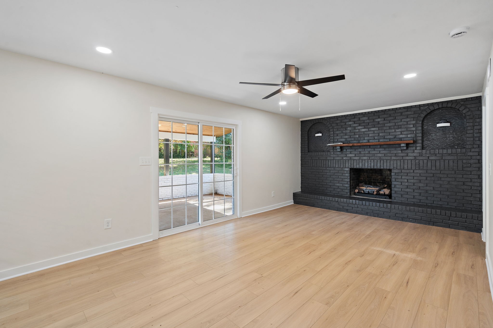 1015 Lock 4 Road Gallatin, TN 37066 - Photo 13 of 47 a view of an empty room with a fireplace and a window