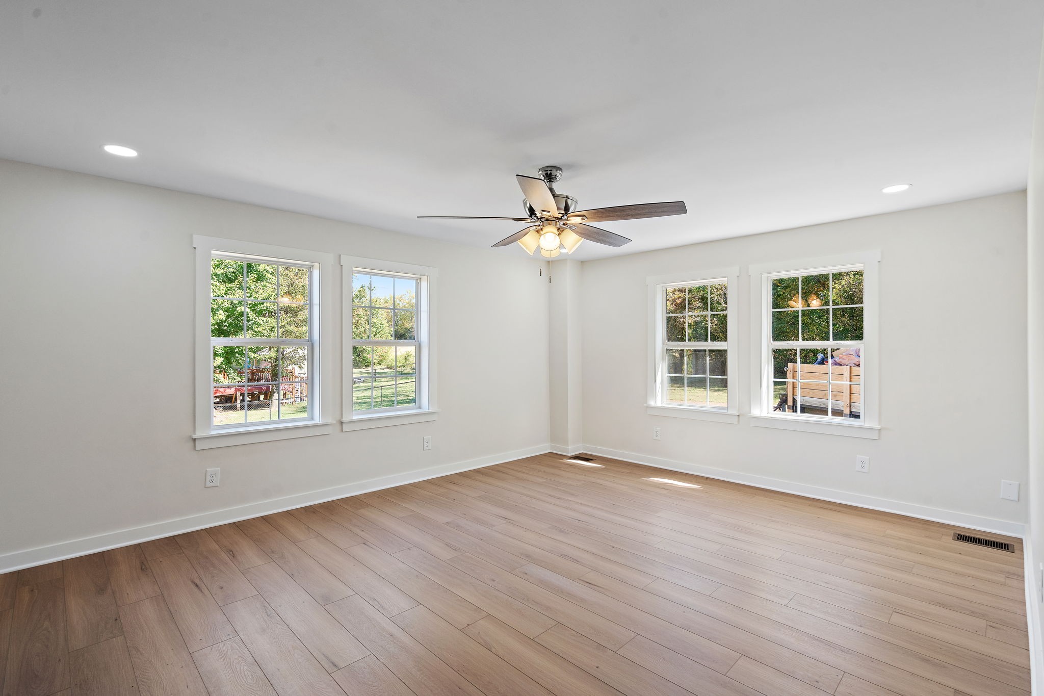 1015 Lock 4 Road Gallatin, TN 37066 - Photo 16 of 47 a view of an empty room with wooden floor and a window