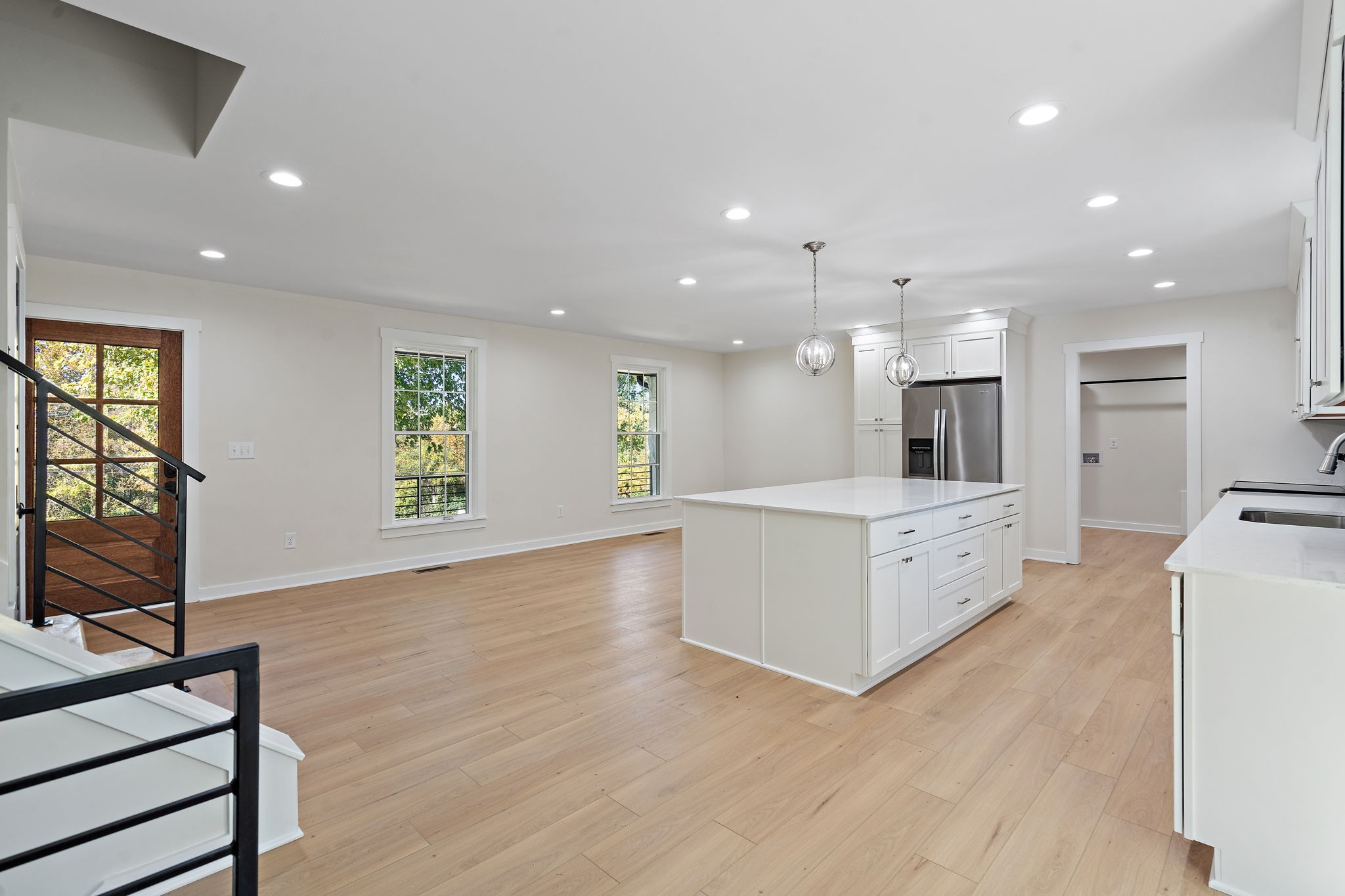 1015 Lock 4 Road Gallatin, TN 37066 - Photo 6 of 47 a large white kitchen with wooden floor and a sink