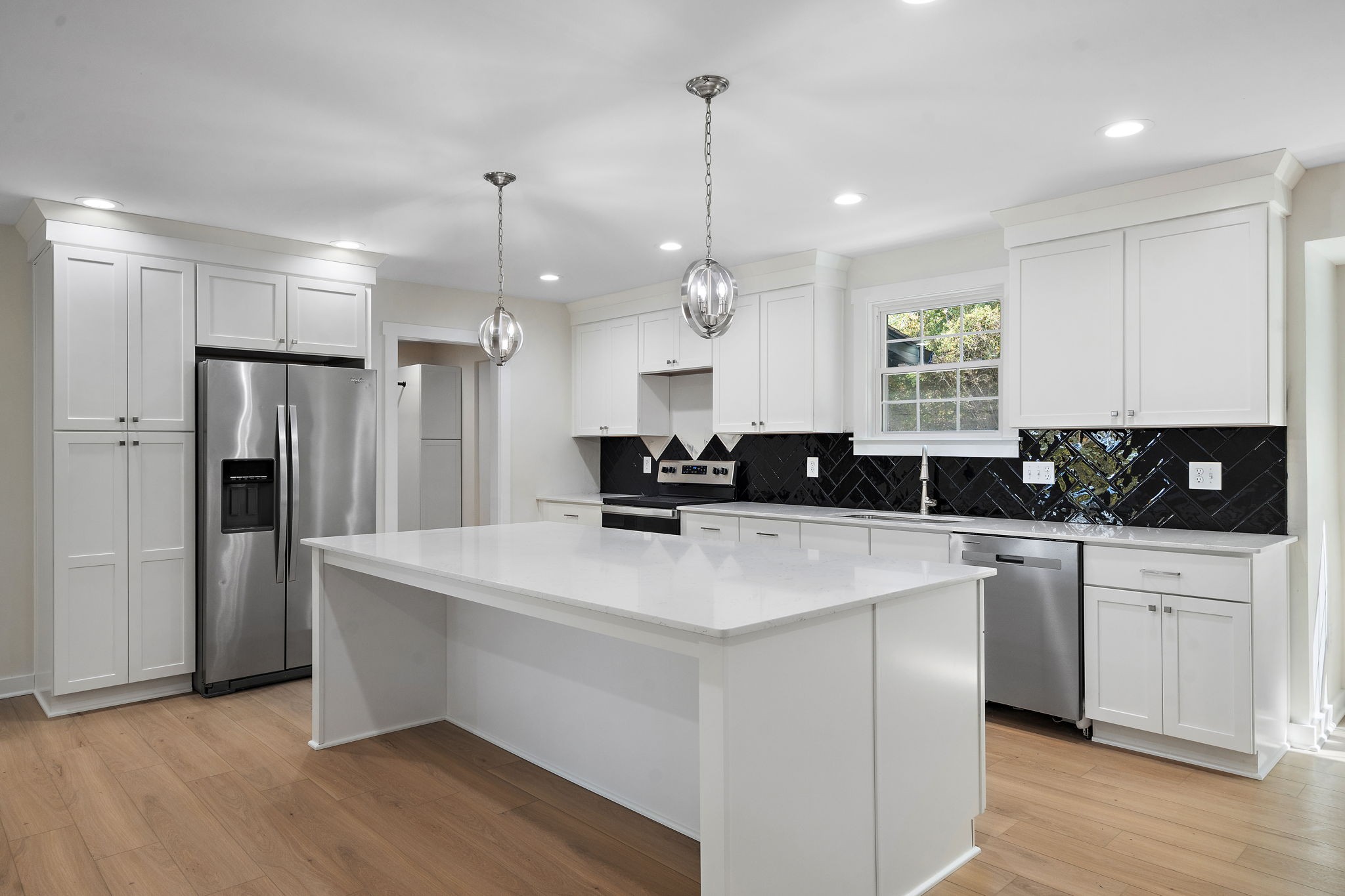 1015 Lock 4 Road Gallatin, TN 37066 - Photo 7 of 47 a kitchen with stainless steel appliances granite countertop a sink a stove a refrigerator and island with wooden floor
