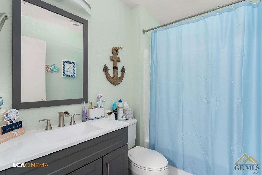 Undisclosed Address Bakersfield, CA 93307 - Photo 14 of 18 a bathroom with a sink a toilet and shower