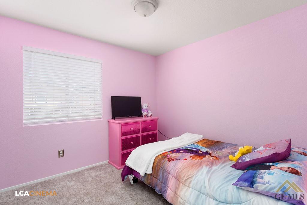 Undisclosed Address Bakersfield, CA 93307 - Photo 15 of 18 a bedroom with a bed and a flat screen tv