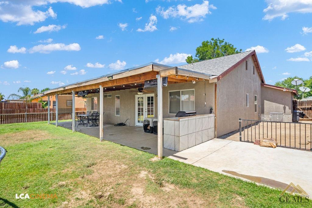 Undisclosed Address Bakersfield, CA 93307 - Photo 17 of 18 a front view of a house with a garden and yard
