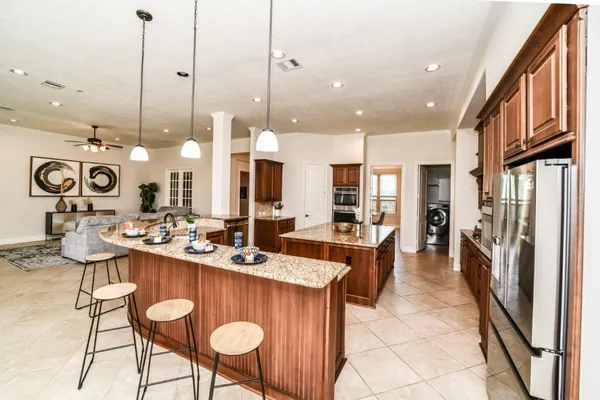 a large kitchen with a table and chairs