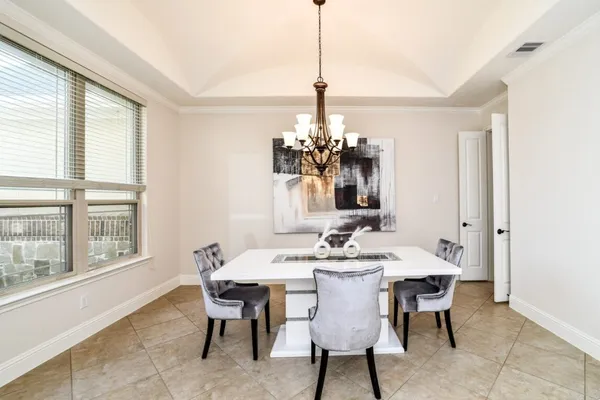 a dining room with furniture and window
