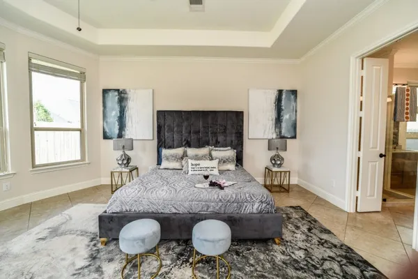 a living room with furniture and large windows