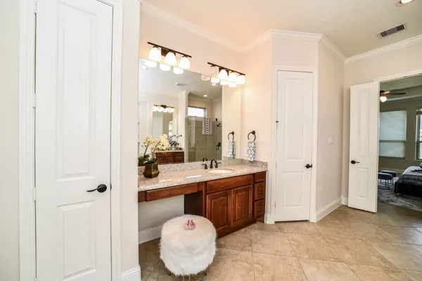 a bathroom with a tub a sink and a large mirror
