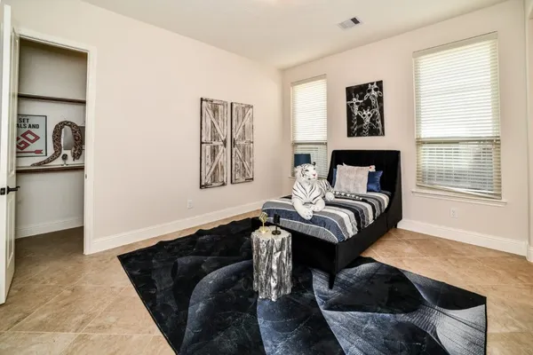 a living room with furniture a window and a potted plant