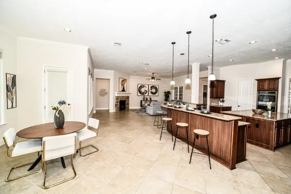 a large kitchen with lots of counter space and furniture