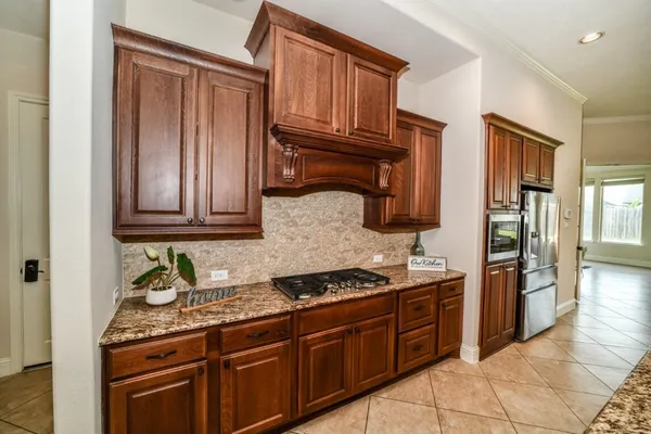 a kitchen with granite countertop cabinets and steel stainless steel appliances