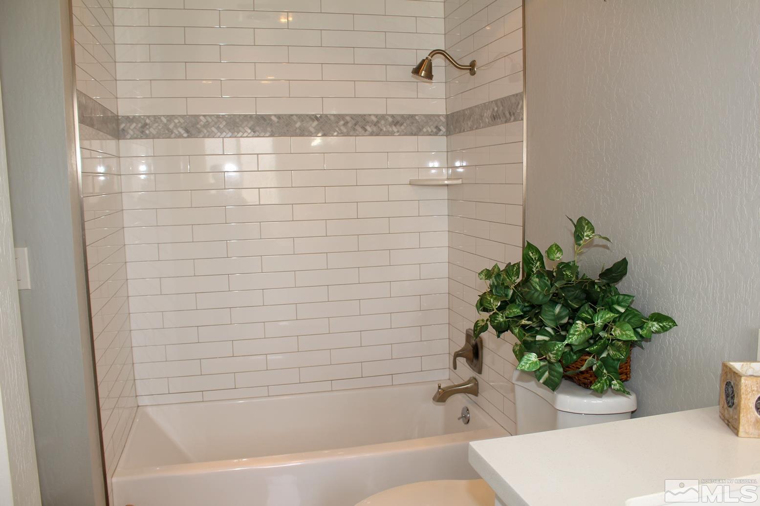 7775 Tamra Drive Reno, NV 89506 - Photo 19 of 40 a bathroom with a bathtub and shower