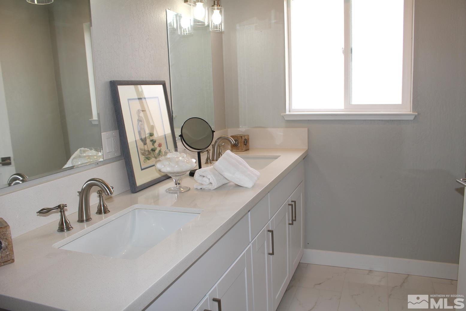 7775 Tamra Drive Reno, NV 89506 - Photo 20 of 40 a bathroom with double sink and a mirror