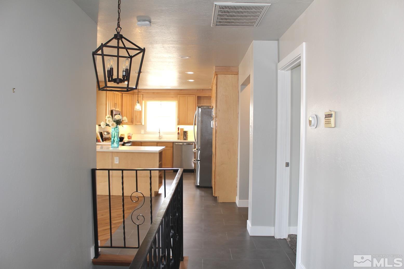 7775 Tamra Drive Reno, NV 89506 - Photo 27 of 40 a view of a hallway with wooden floor and windows