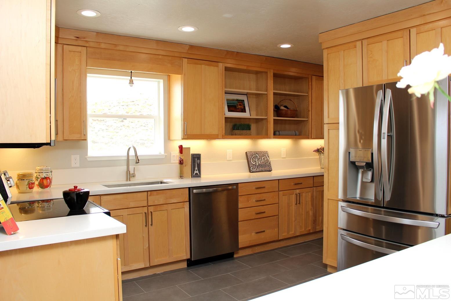 7775 Tamra Drive Reno, NV 89506 - Photo 4 of 40 a kitchen with a sink stainless steel appliances and cabinets