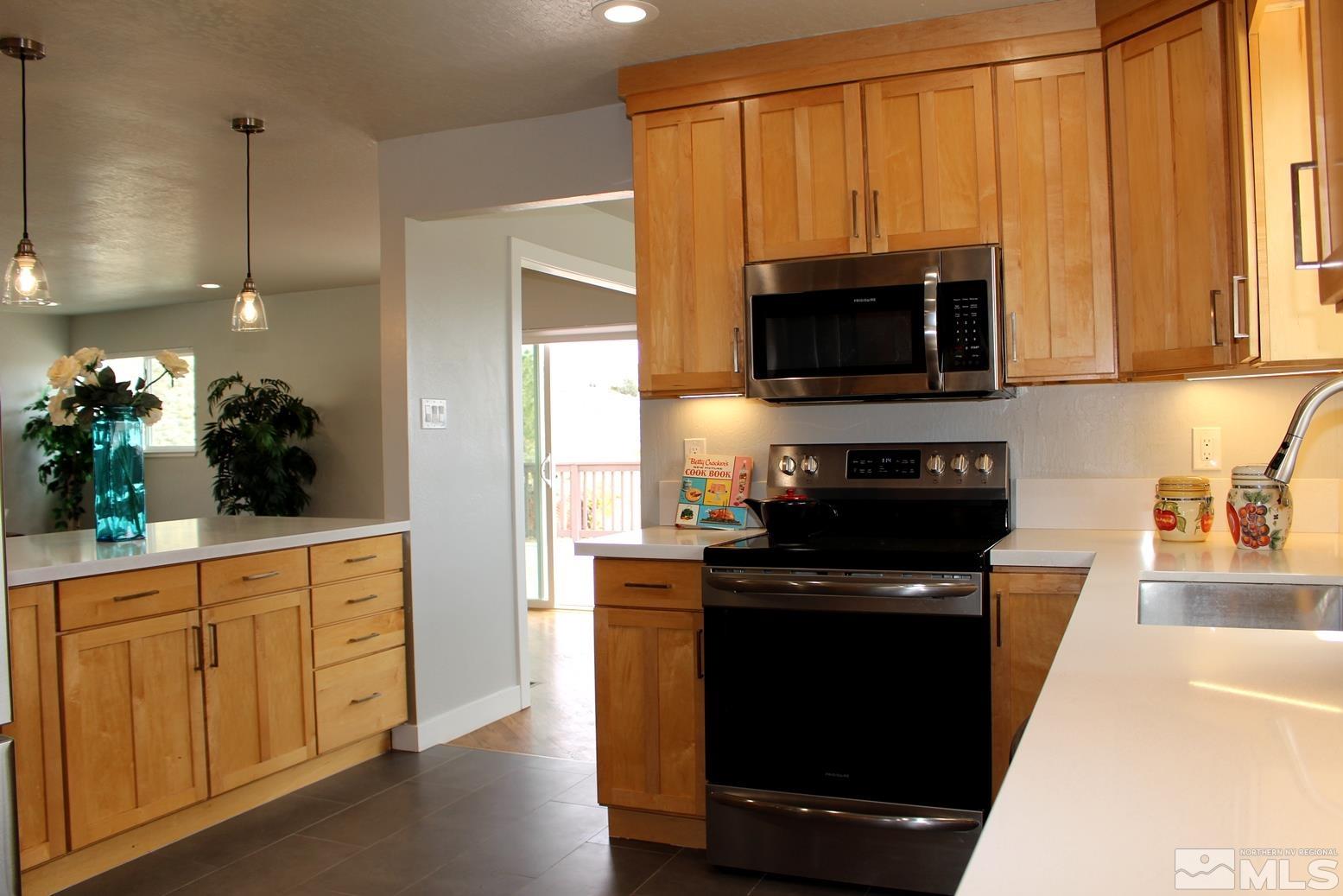 7775 Tamra Drive Reno, NV 89506 - Photo 5 of 40 a kitchen with a stove and a microwave