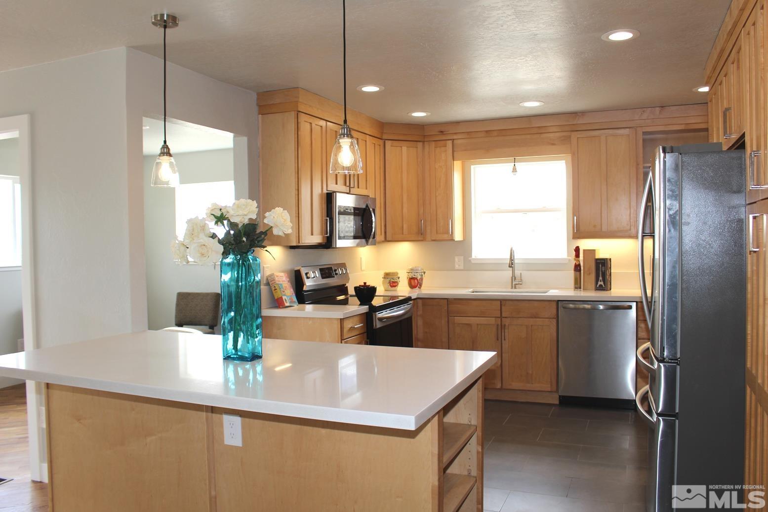 7775 Tamra Drive Reno, NV 89506 - Photo 9 of 40 a kitchen with a sink a counter top space and stainless steel appliances