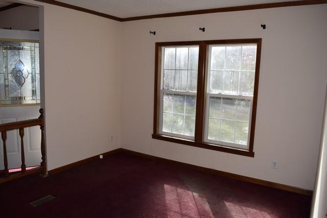 615 Adams Loop Tennessee Ridge, TN 37178 - Photo 9 of 18 a view of an empty room with wooden floor and a window