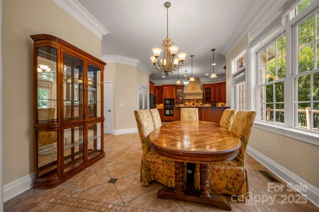 a dining room with furniture a chandelier and wooden floor