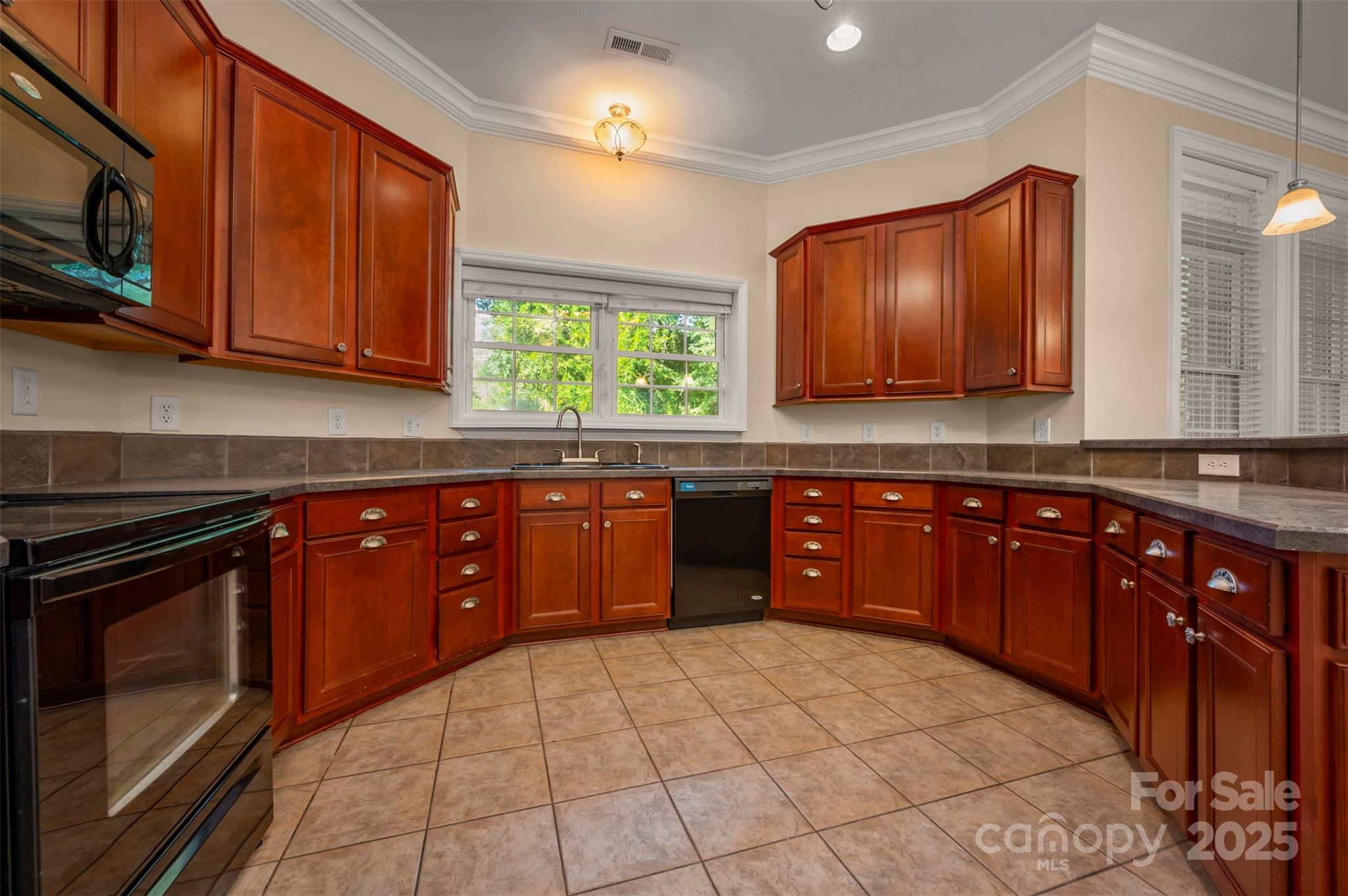 288 Palms Way Forest City, NC 28043 - Photo 29 of 47 a kitchen with stainless steel appliances granite countertop a stove sink and cabinets